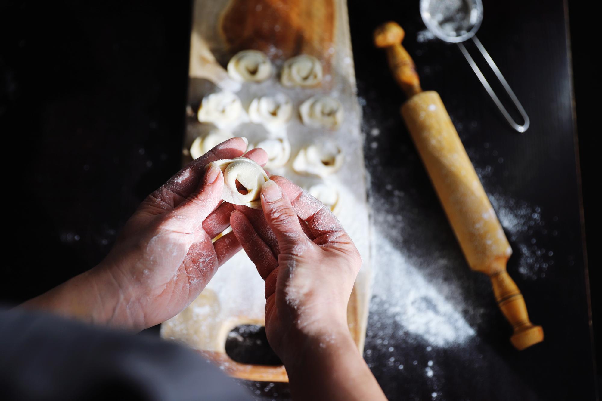Artisan kitchen close-up with hands preparing pastry